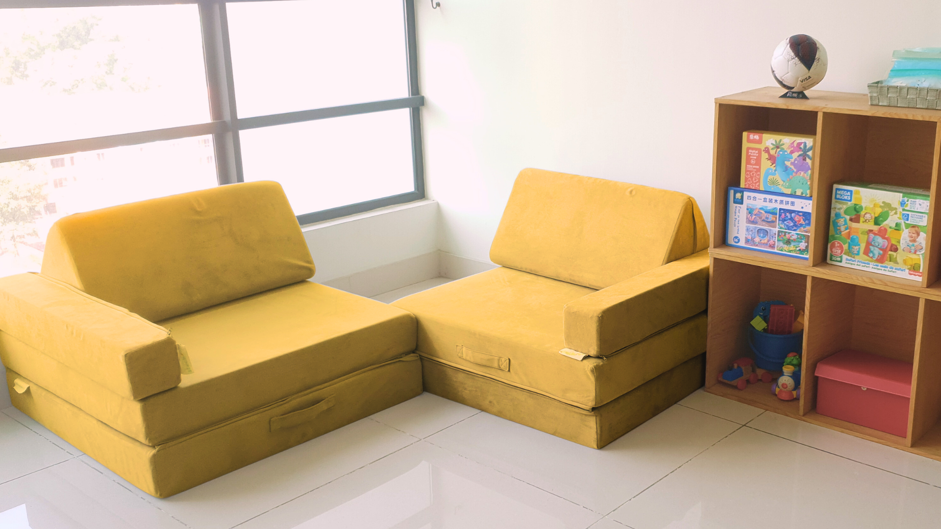 Yellow stackies (a malaysian modular play couch, modular kids play sofa in malaysia) in use as a couches and kid sofa in a reading corner. perfect kids furniture for your home. 